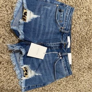 distressed Kancan shorts with leopard pockets.